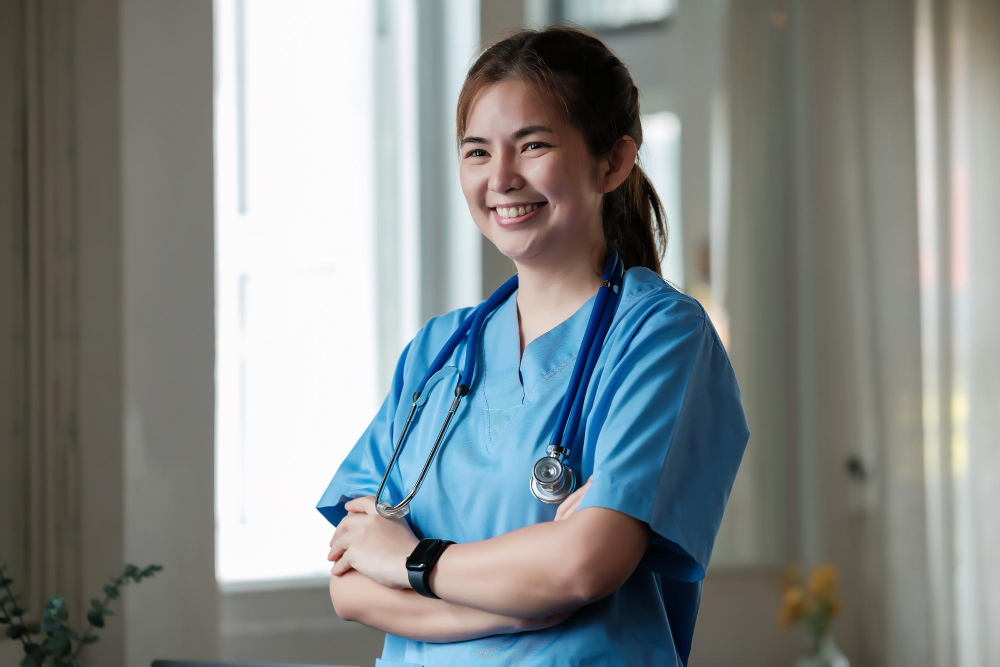 Smiling private duty nurse in blue scrubs ready to work in NYC